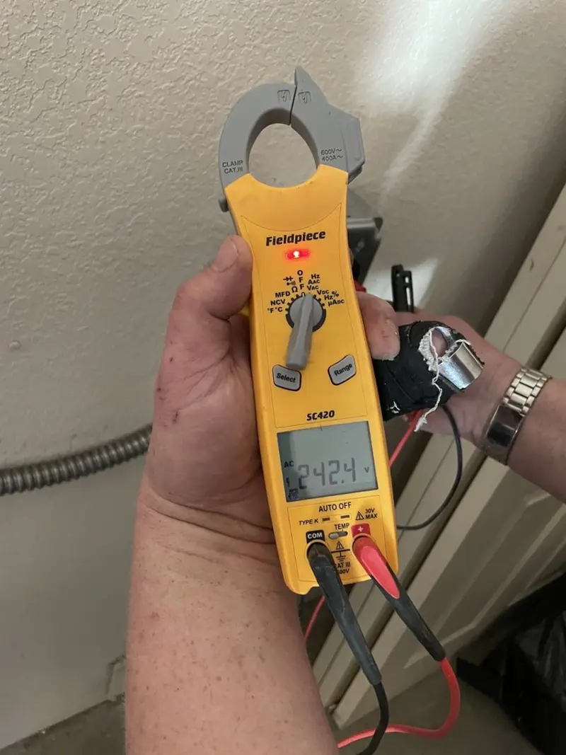 Voltage testing with clamp meter during Ceiling Fan Installation in Cleveland
